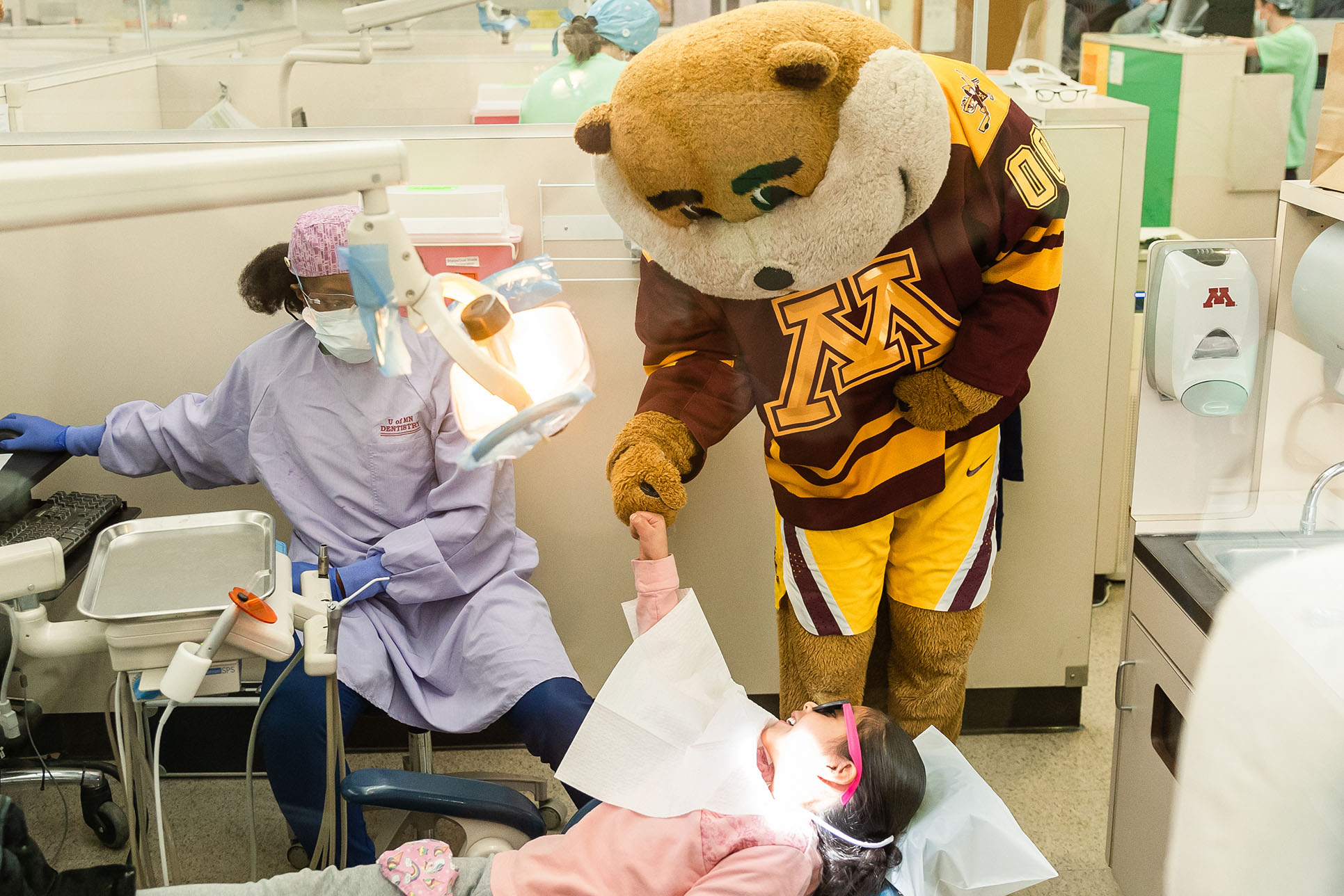 Goldy Gopher greets a patient at the University of Minnesota Dental Clinics