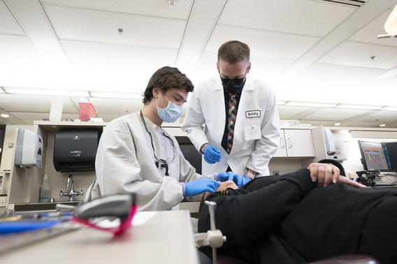 A faculty member works with an orthodontics resident