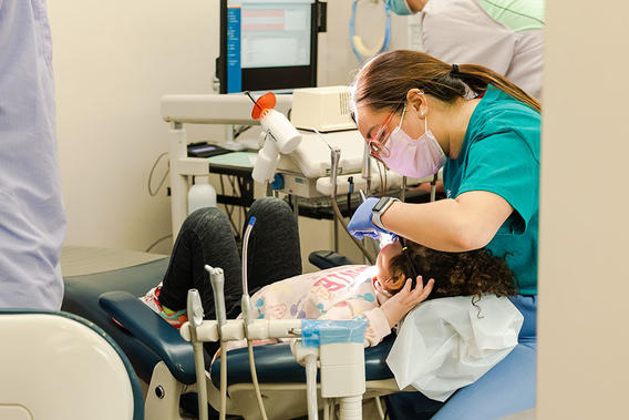 Dental student treats a child