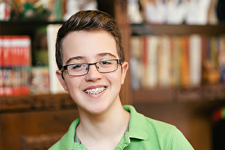 Child wearing braces and smiling